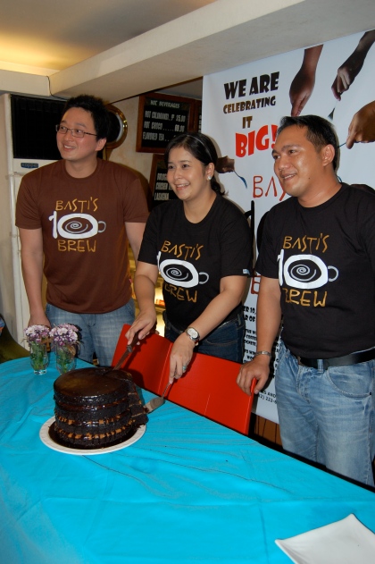 Owners Randall Ong and Vanessa Ong, and Store Manager Paul Aseneta with the monster choco caramel cake